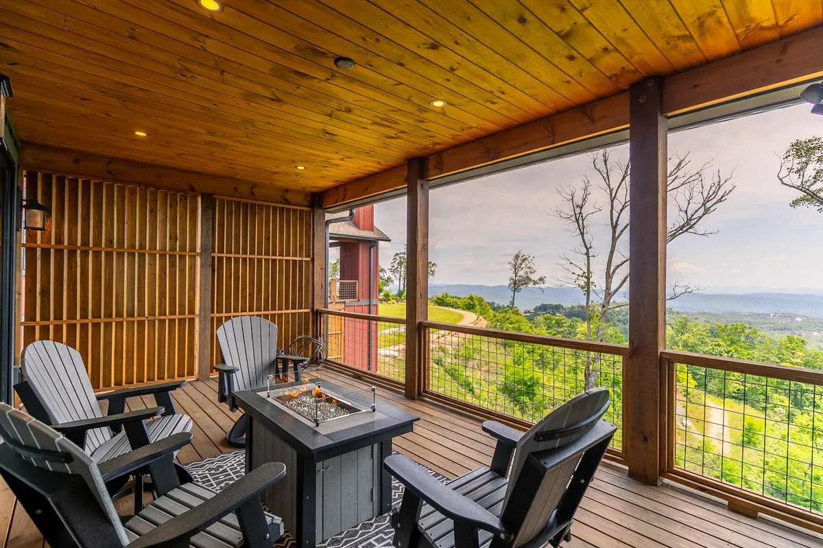 An outdoor fire pit encircled by Adirondack chairs offers a panoramic view of the mountains. The scene is set for gatherings, relaxation after a day’s adventure, and sharing stories under the stars, resonating with the section’s emphasis on evenings spent outdoors.